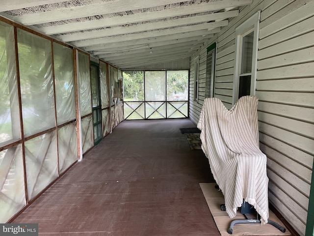 unfurnished sunroom with vaulted ceiling