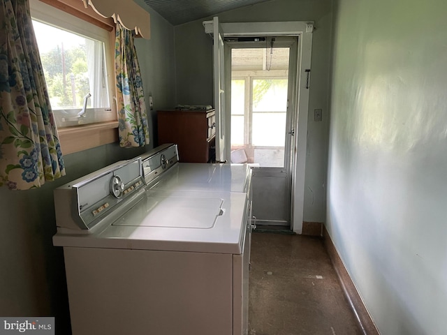 laundry room with washing machine and dryer and a healthy amount of sunlight