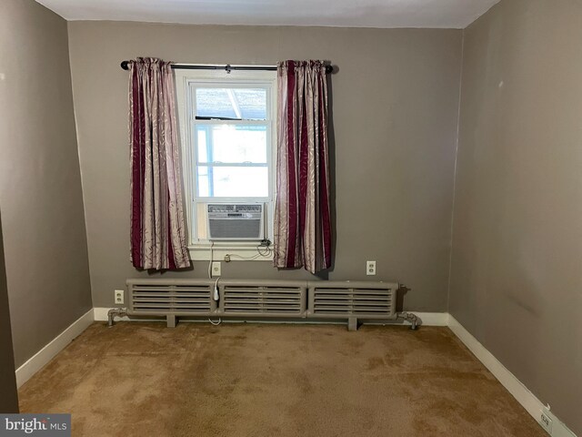 empty room featuring light carpet and cooling unit