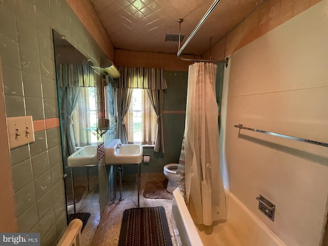 bathroom with toilet and shower / bathtub combination with curtain