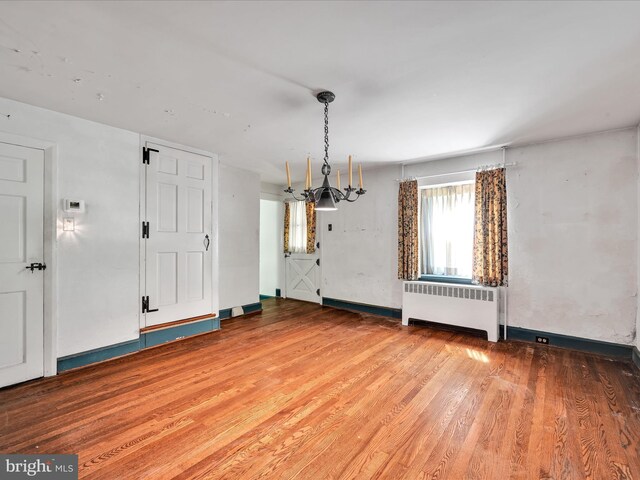 interior space with hardwood / wood-style floors and radiator