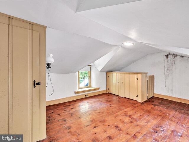 bonus room featuring hardwood / wood-style flooring and vaulted ceiling