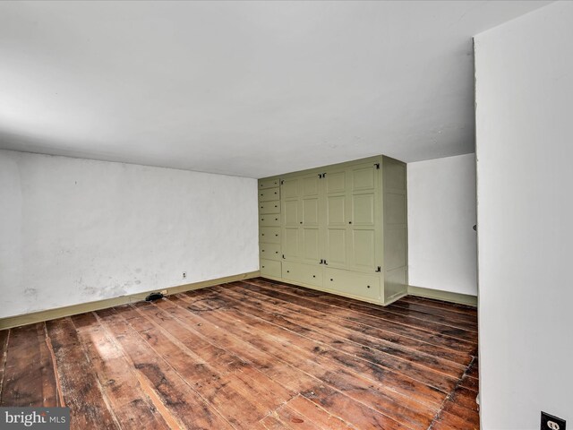 unfurnished bedroom with dark wood-type flooring