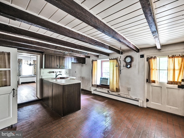 kitchen featuring beam ceiling, a healthy amount of sunlight, a baseboard radiator, and dark brown cabinets