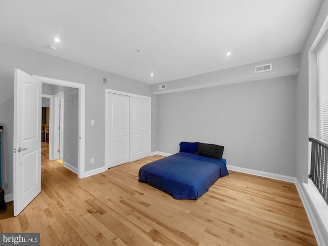 bedroom featuring light wood-type flooring and a closet