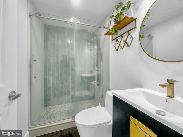 bathroom featuring walk in shower, vanity, and toilet