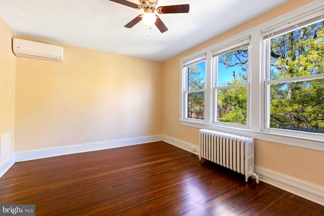 empty room featuring ceiling fan, dark hardwood / wood-style flooring, an AC wall unit, and radiator