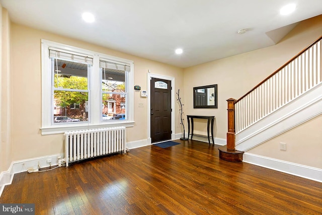 entrance foyer with hardwood / wood-style flooring and radiator heating unit