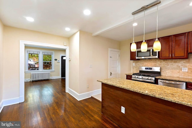 kitchen featuring appliances with stainless steel finishes, radiator heating unit, decorative backsplash, dark hardwood / wood-style floors, and light stone countertops