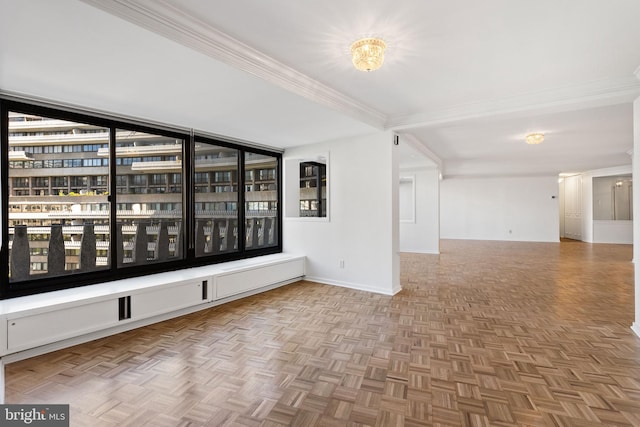 empty room featuring parquet floors and crown molding