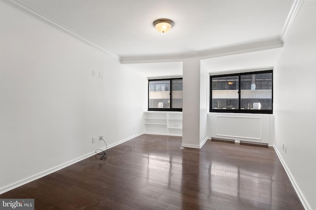 unfurnished room featuring ornamental molding and dark hardwood / wood-style floors