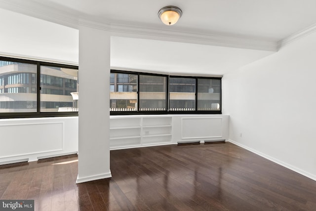 unfurnished room featuring crown molding and dark hardwood / wood-style flooring