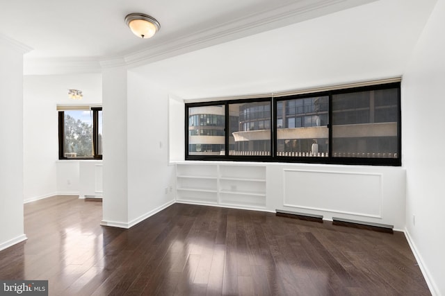 unfurnished room featuring dark hardwood / wood-style floors and crown molding