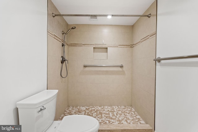 bathroom with toilet and tiled shower