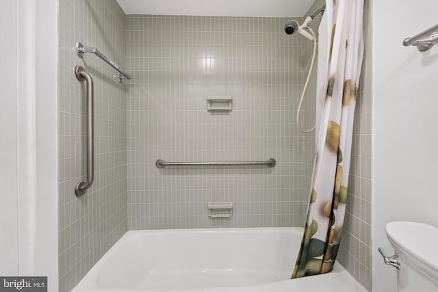 bathroom featuring shower / bath combination with curtain and toilet