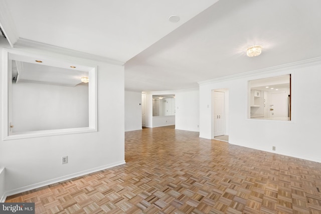 spare room with light parquet floors and crown molding