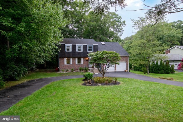 view of front of property with a garage and a front yard