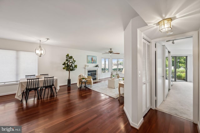 interior space with hardwood / wood-style floors and ceiling fan with notable chandelier