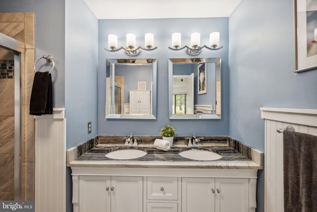 bathroom featuring a sink and double vanity