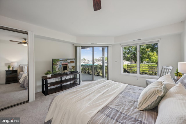 bedroom with access to outside, light colored carpet, and ceiling fan