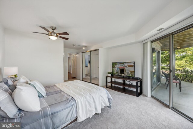 bedroom featuring light carpet, a closet, access to exterior, and ceiling fan