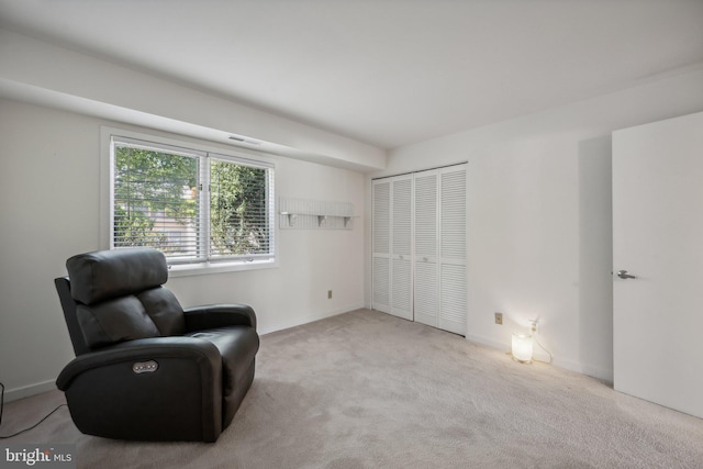 living area with light carpet