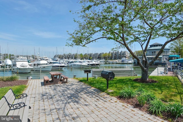 exterior space with a water view and a lawn