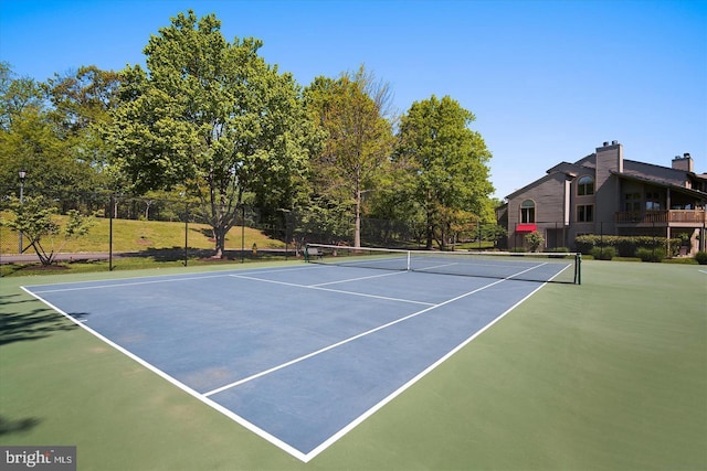 view of sport court featuring fence