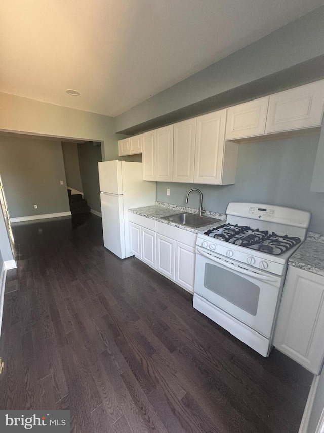 kitchen featuring white cabinetry, sink, dark hardwood / wood-style flooring, and white appliances