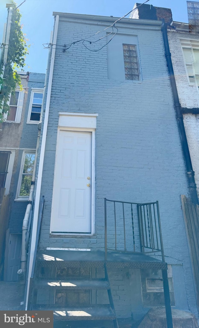 exterior space featuring entry steps and brick siding