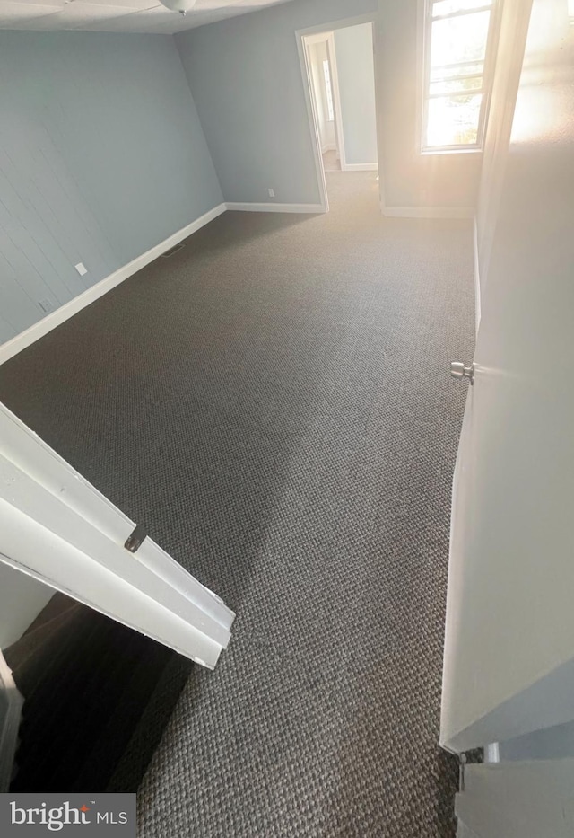 empty room with carpet floors and baseboards