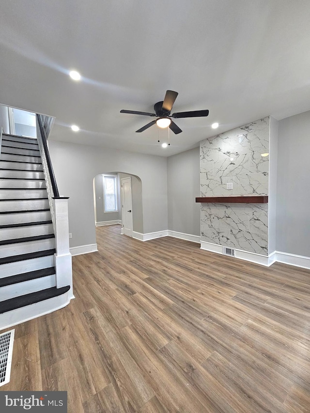 unfurnished living room with hardwood / wood-style floors and ceiling fan