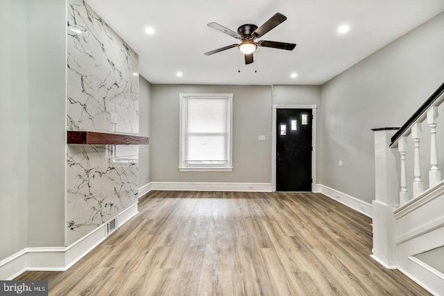 foyer with light wood-style flooring, visible vents, stairway, and recessed lighting