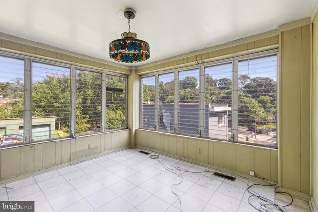 unfurnished sunroom featuring a healthy amount of sunlight