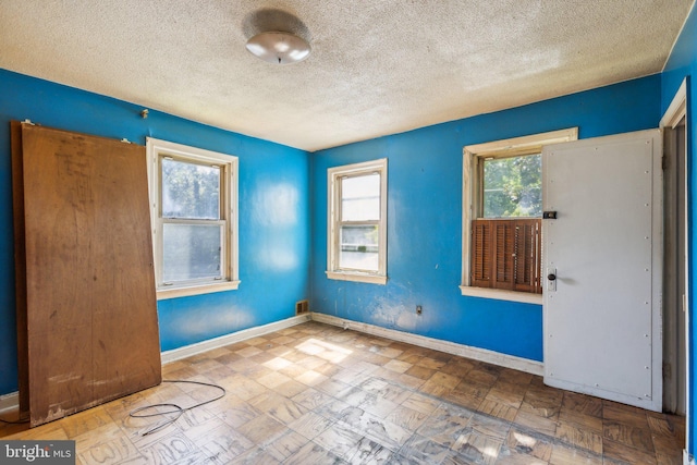 spare room featuring a textured ceiling