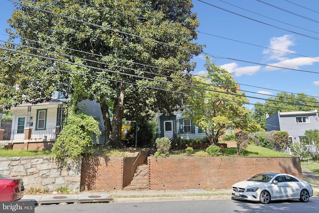 view of property hidden behind natural elements featuring stairway