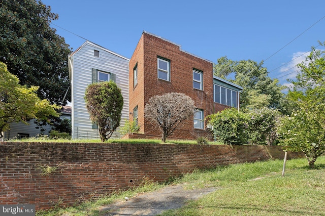 view of side of property featuring brick siding