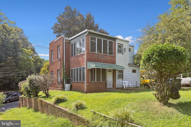 rear view of house with a lawn