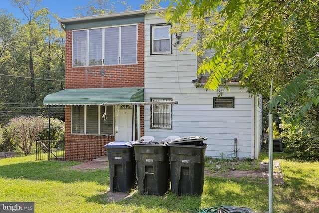 rear view of house with a yard