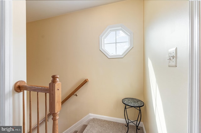 stairway featuring carpet floors and baseboards