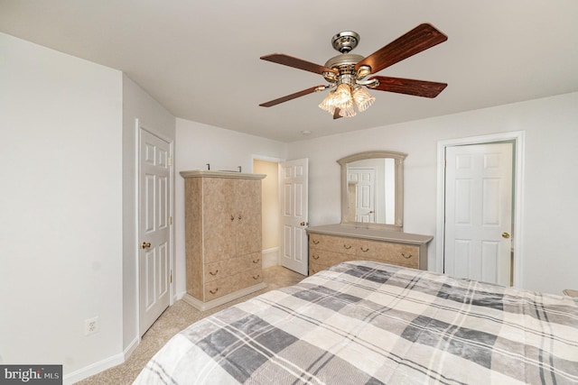 bedroom with baseboards, a ceiling fan, and light colored carpet