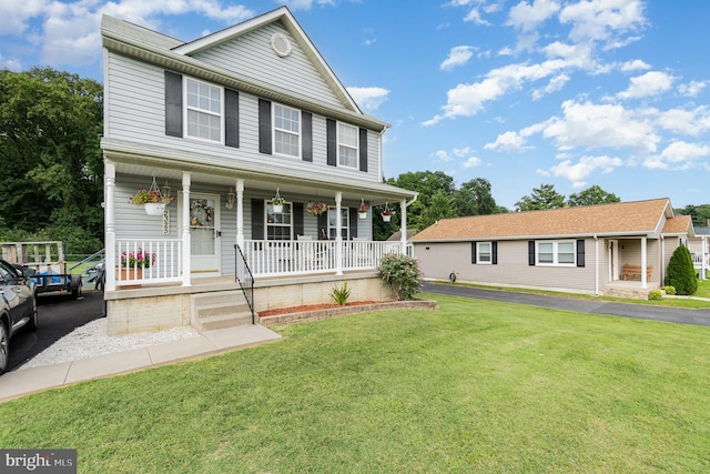 view of front of home with a porch and a front yard