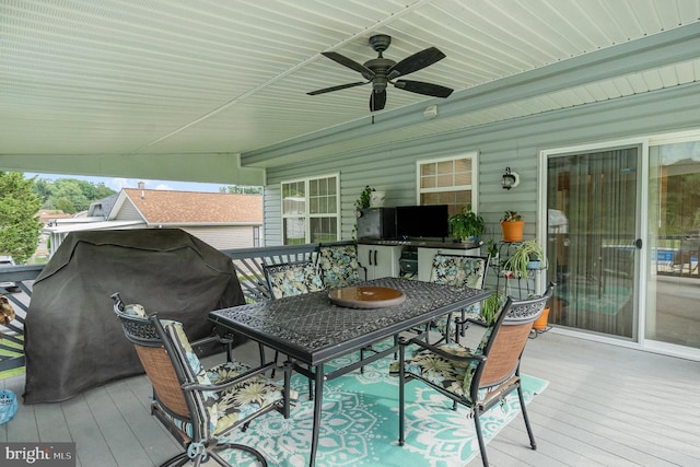 wooden deck with ceiling fan and outdoor dining area