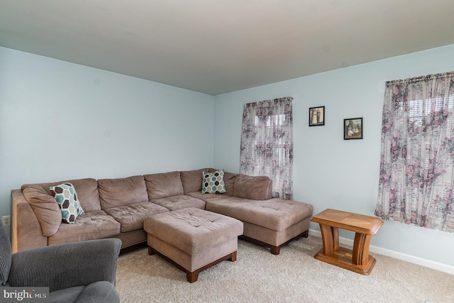 living room with light carpet and baseboards