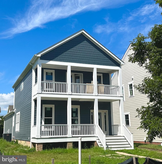 back of property featuring a balcony, a yard, covered porch, and cooling unit