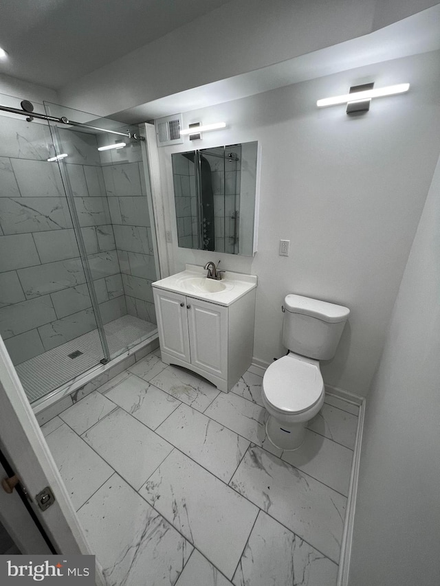 bathroom with tile patterned flooring, an enclosed shower, vanity, and toilet