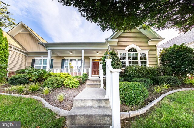 view of exterior entry featuring covered porch