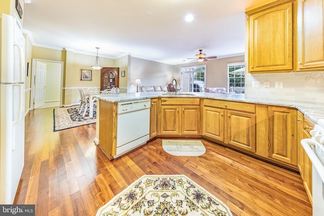 kitchen featuring white appliances, light hardwood / wood-style flooring, tasteful backsplash, kitchen peninsula, and ceiling fan