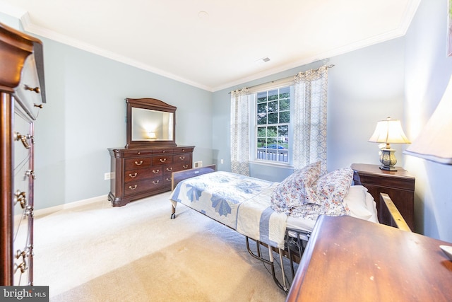 carpeted bedroom with ornamental molding