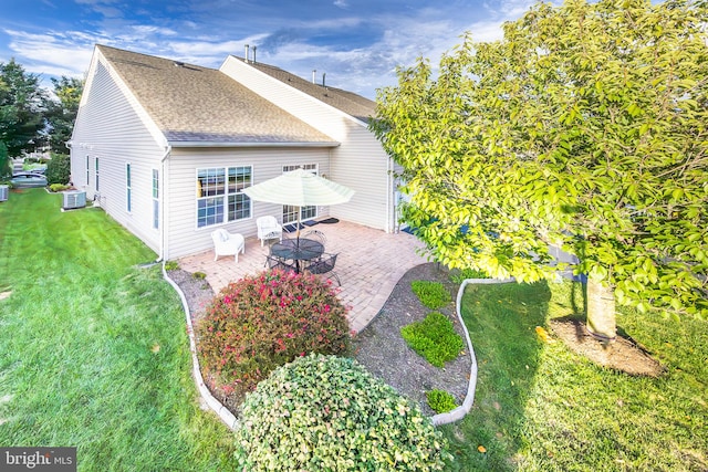 back of house with a yard and a patio area